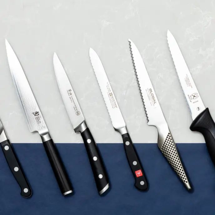 An image of a collection of serrated knives. What is the purpose of a serrated knife?