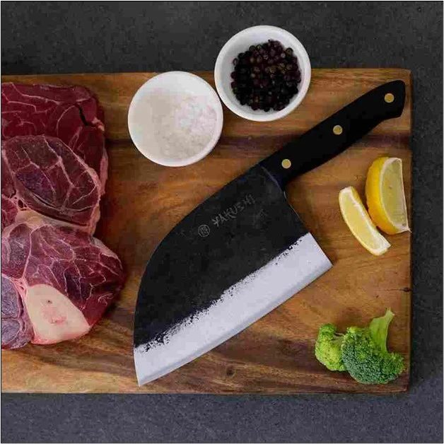 An image of a cleaver in use. What is a butcher's cleaver?
