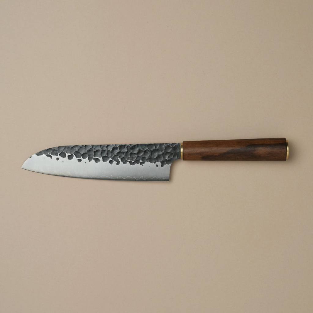An image of a santoku knife on a cream-ish surface. What is a santoku knife good for?