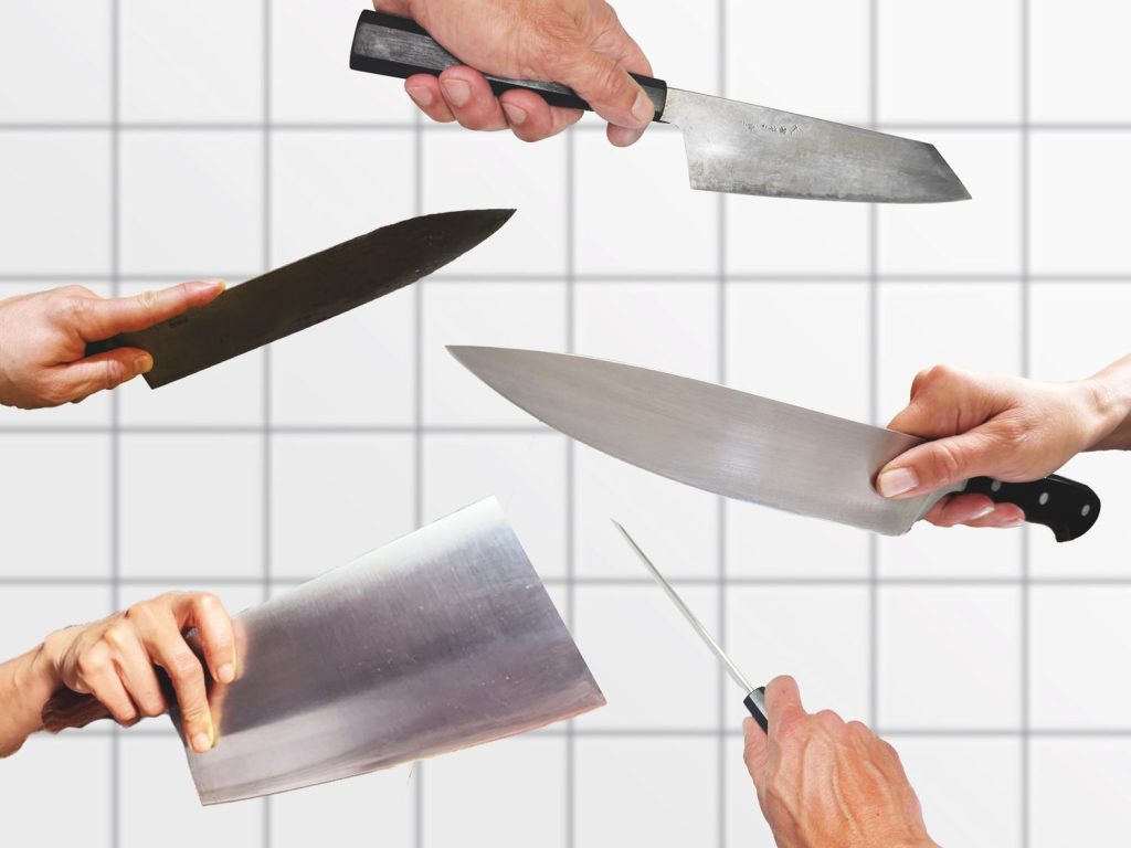 An image of a collection of knives and how to hold them. Kitchen best practices on full display.